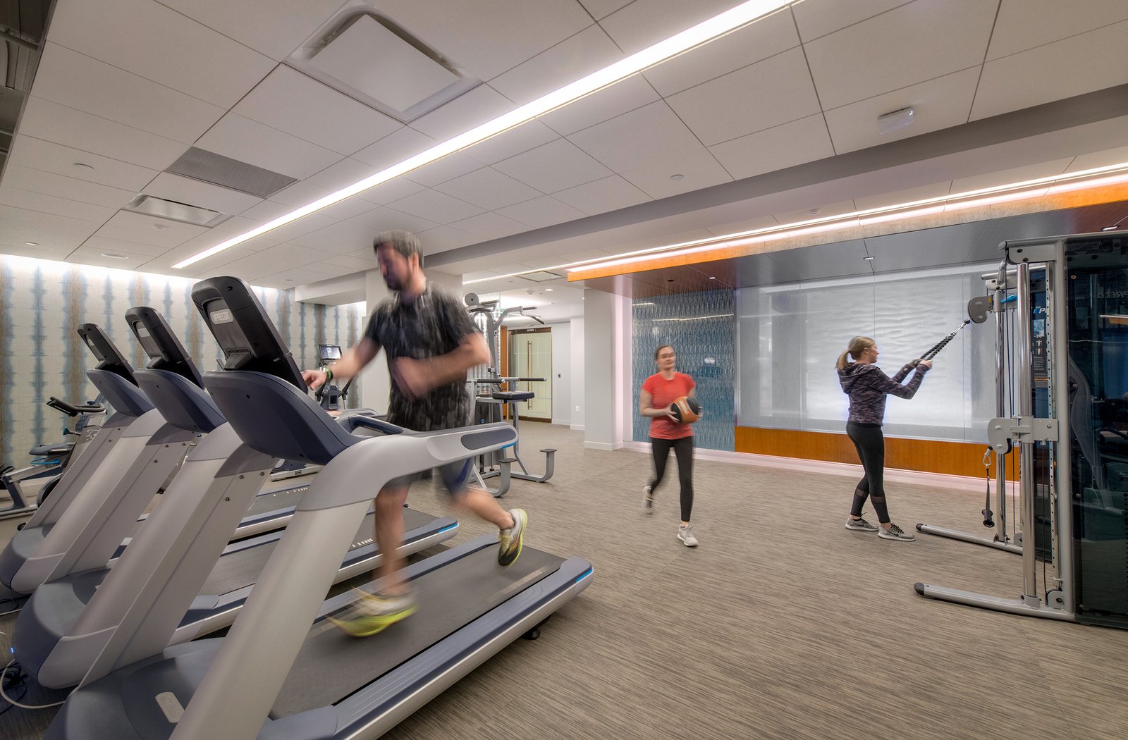 Image of treadmills and weights machines at the state-of-the-art on-site fitness center at 1500 K Street