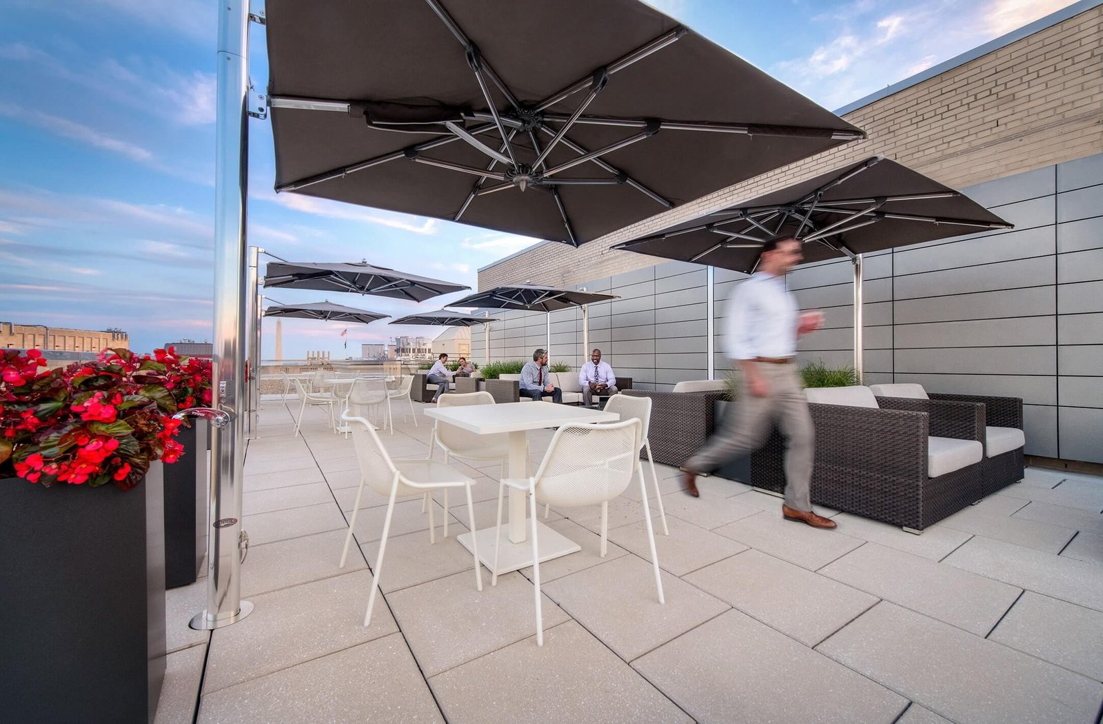 Image of the 1500 K Street rooftop terrace, with outdoor furniture, umbrellas and striking views.